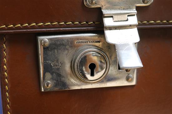 A leather travelling toilet case containing four late Victorian silver mounted jars and thirteen tortoiseshell mounted items.